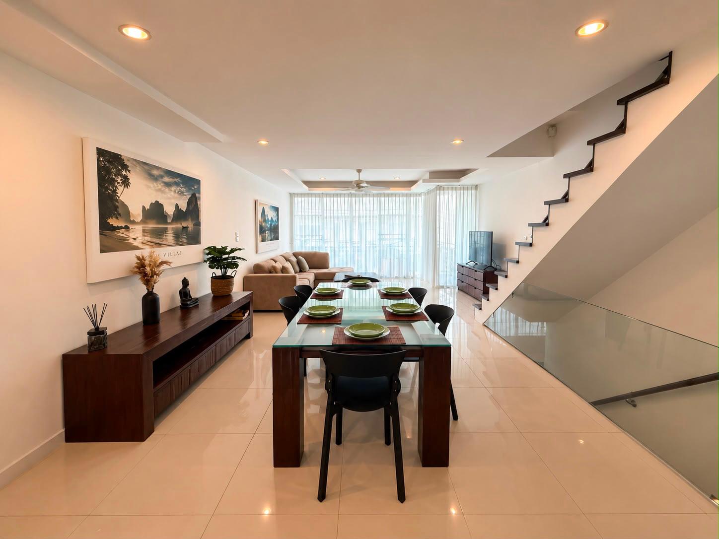 Living room with staircase and sea-view balcony