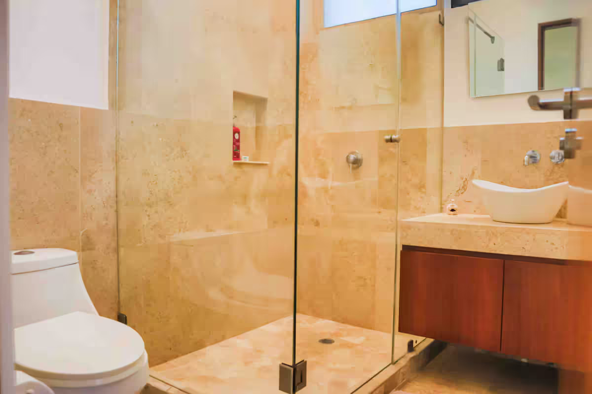 Travertine bathroom with walk-in glass shower